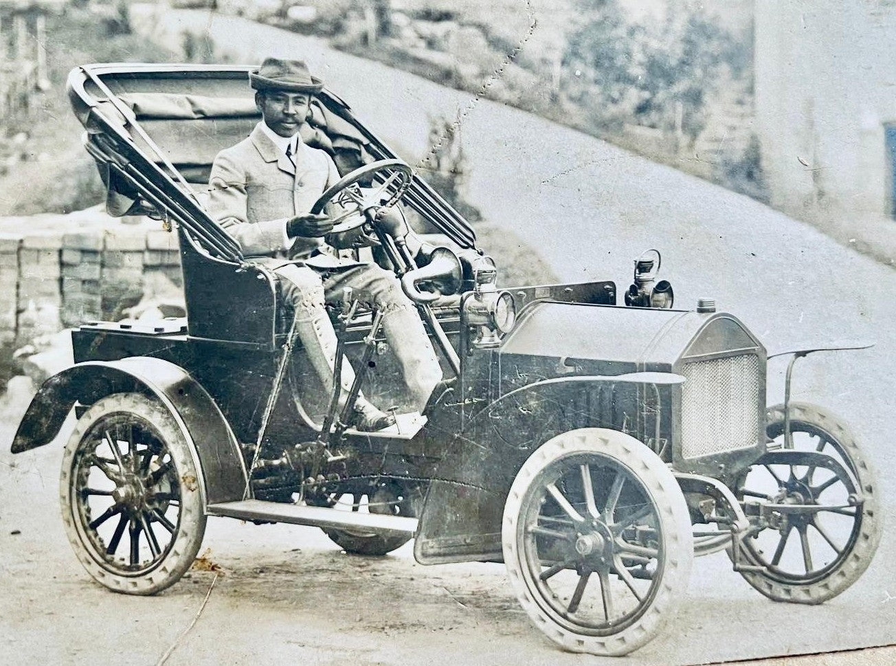 Christian De Rivel's grandfather seated in an early automobile